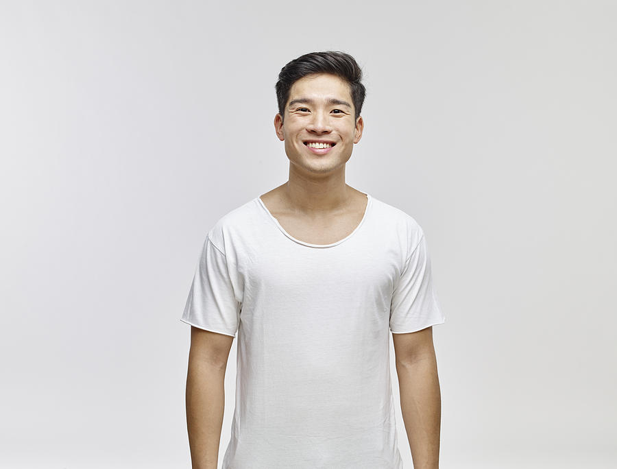 Portrait of smiling young man wearing white t-shirt Photograph by Westend61