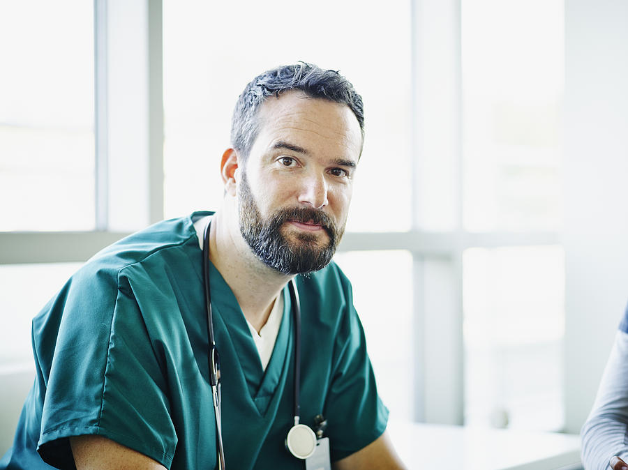 Portrait of surgeon wearing scrubs in hospital Photograph by Thomas Barwick