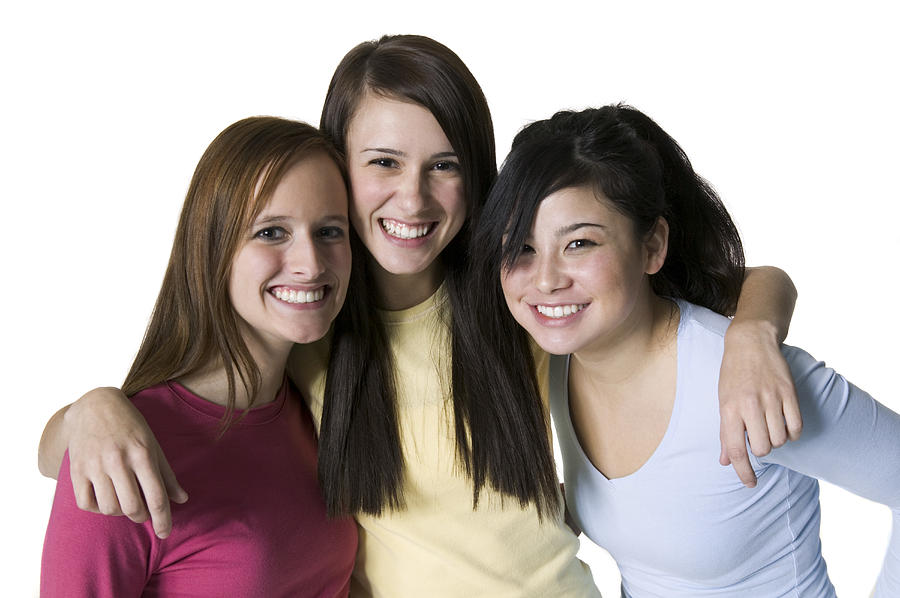 Portrait of three teenage girls standing together smiling Photograph by Photodisc