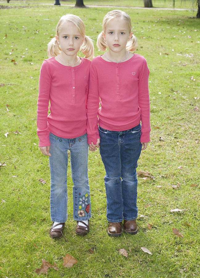 Portrait of twin sisters (6-7) in park Photograph by Sheer Photo, Inc