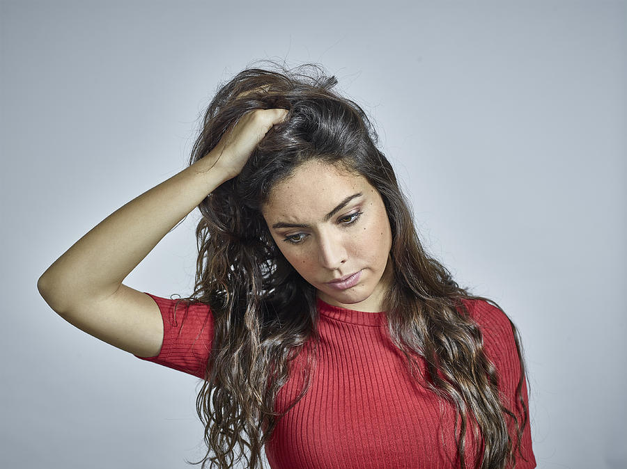 Portrait of young brunette female holding hair Photograph by Mike Harrington