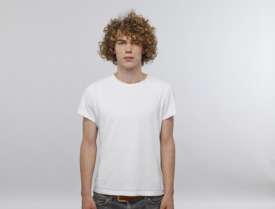 Portrait of young man with curly blond hair wearing white t-shirt Photograph by Westend61