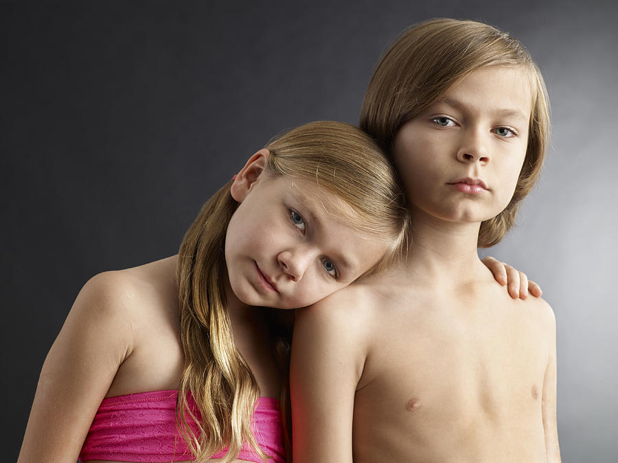 Portrait of young sister and brother in studio Photograph by Blake Little