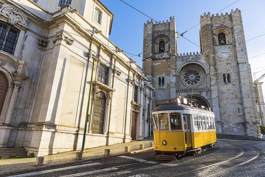 Portugal, Lisbon, typical yellow tram in front of the Cathedral Photograph by Westend61