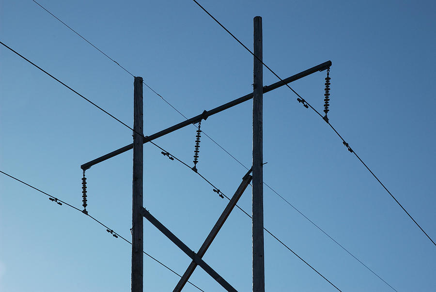 Powerlines silhouetted against the blue autumn sky Photograph by Rob Huntley