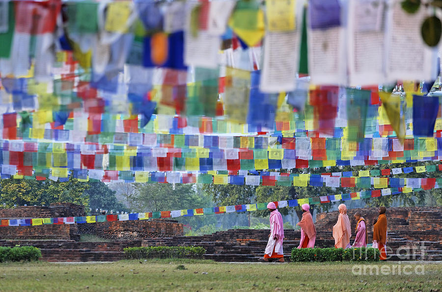 Lumbini Photograph - Prayer flags and novice monks at Lumbini in Nepal by Robert Preston