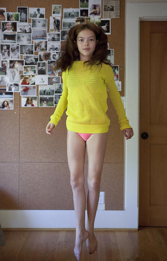 Pre-Teen practicing ballet in her room Photograph by Catherine Ledner