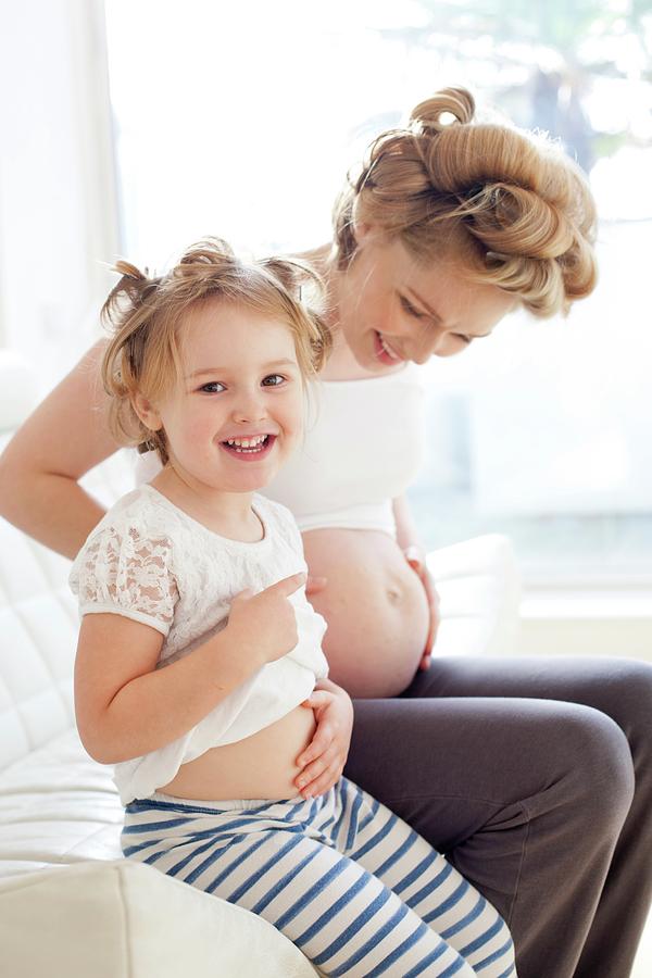 Pregnant Woman And Daughter Smiling Photograph By Ian Hooton Science