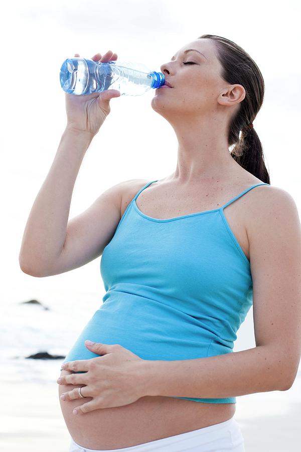 Pregnant Woman Drinking Water Photograph by Ian Hooton/science Photo Library