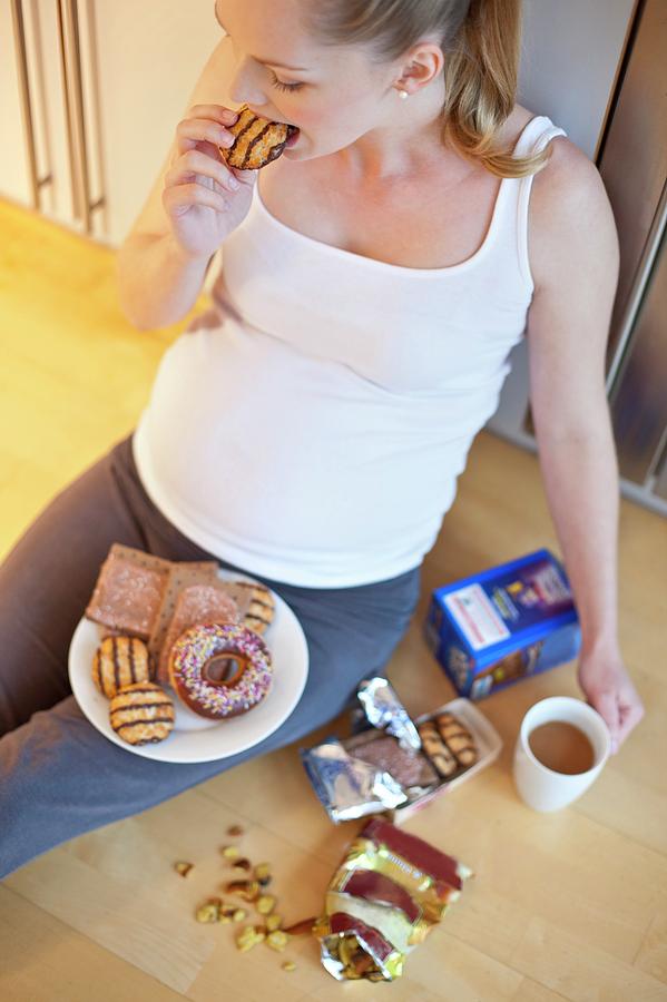 pregnant-woman-eating-biscuit-photograph-by-ian-hooton-science-photo