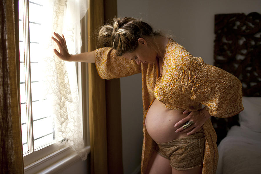 Pregnant woman In labour contractions at home Photograph by Wander Women Collective
