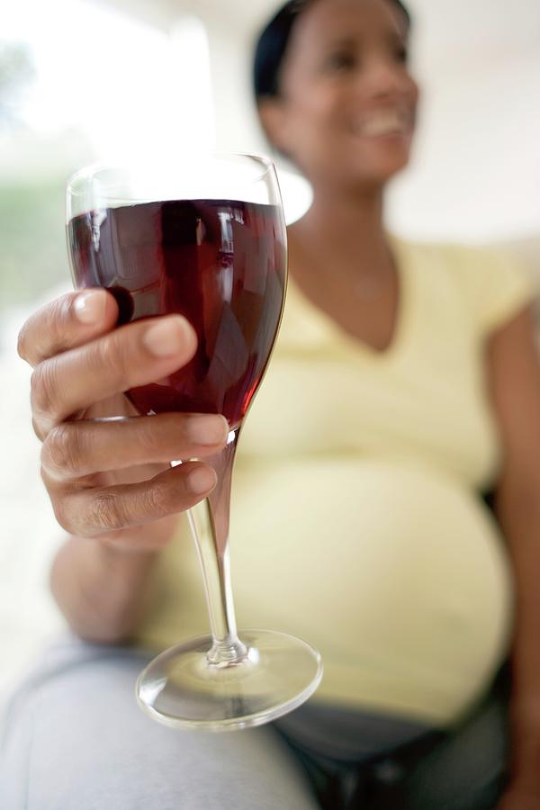 Pregnant Woman With A Glass Of Red Wine Photograph by Ian Hooton/science Photo Library