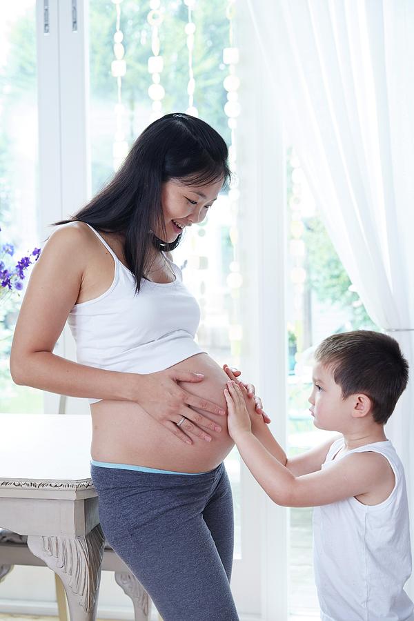 Portrait Photograph - Pregnant Woman With Son Touching Tummy by Ruth Jenkinson