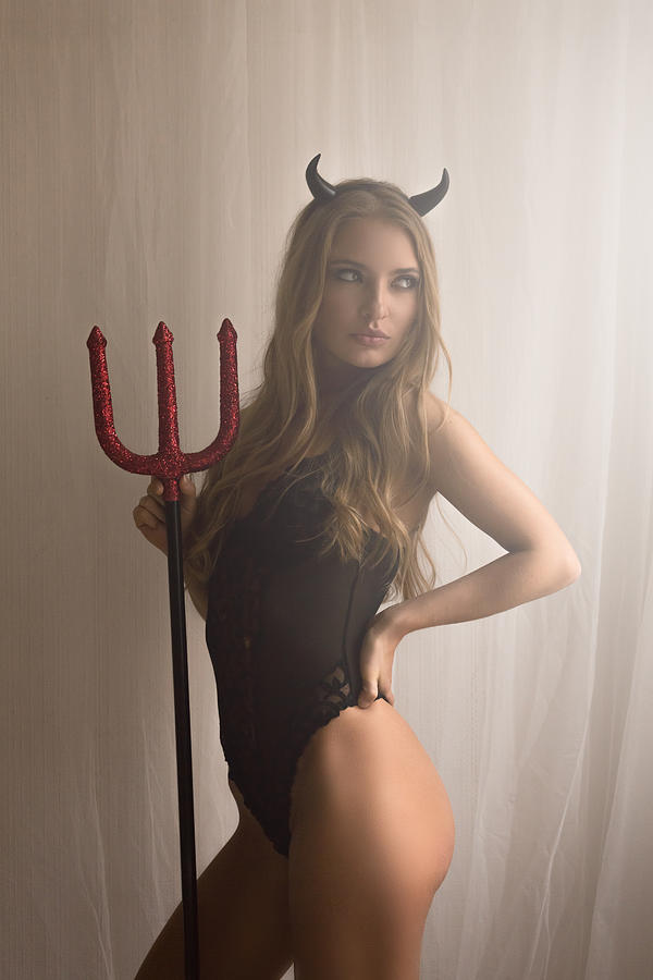 Pretty girl wearing a devil costume Photograph by Peter Zelei Images