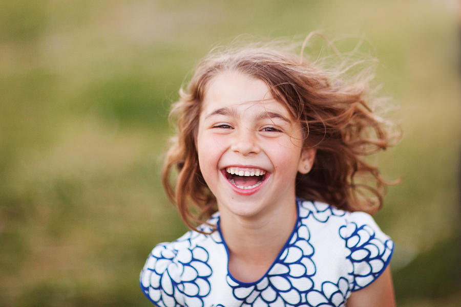 Pretty young girl laughing Photograph by Photo by Rafa Elias