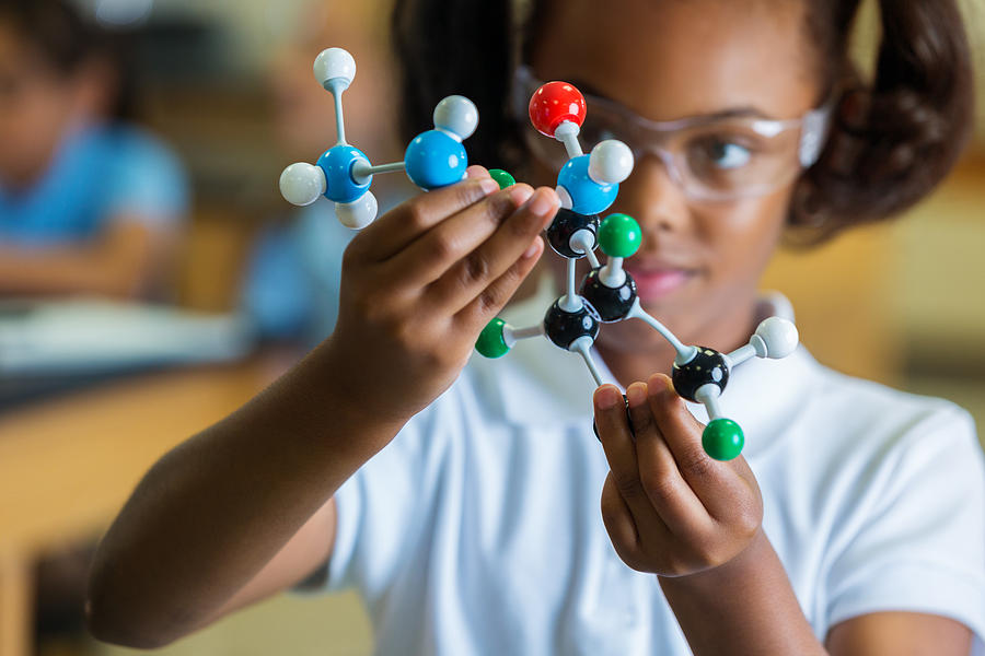 Private elementary school girl examines molecular structure Photograph by SDI Productions