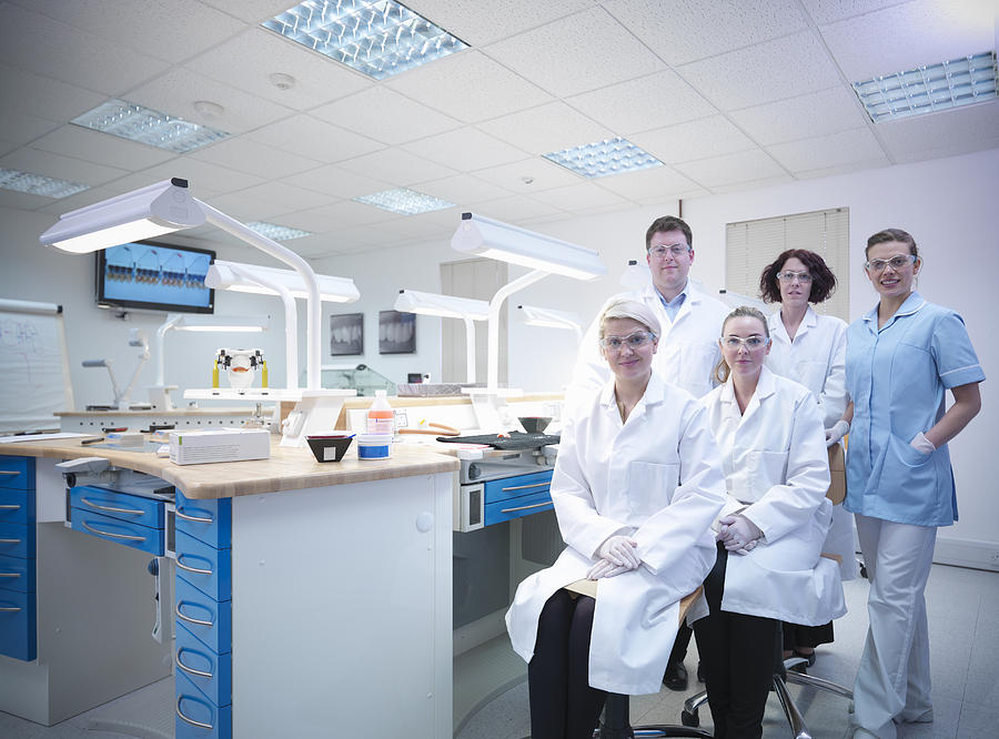 Professional dentists and apprentices in dental laboratory Photograph by Monty Rakusen