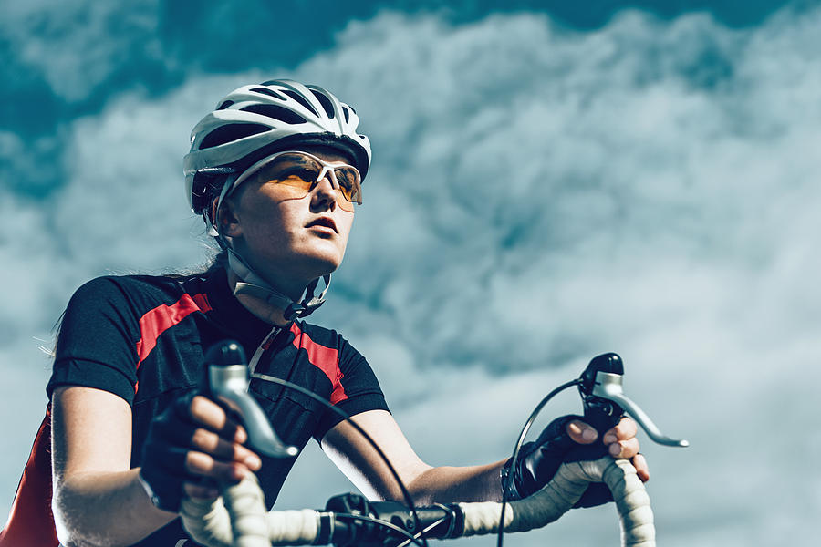 Professional female bike rider rides bicycle Photograph by Mikkelwilliam
