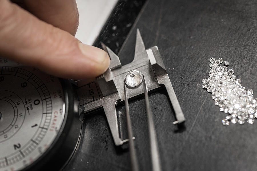 Professional gemstone settings jewellery craft laboratory: Choosing diamonds Photograph by Ilbusca