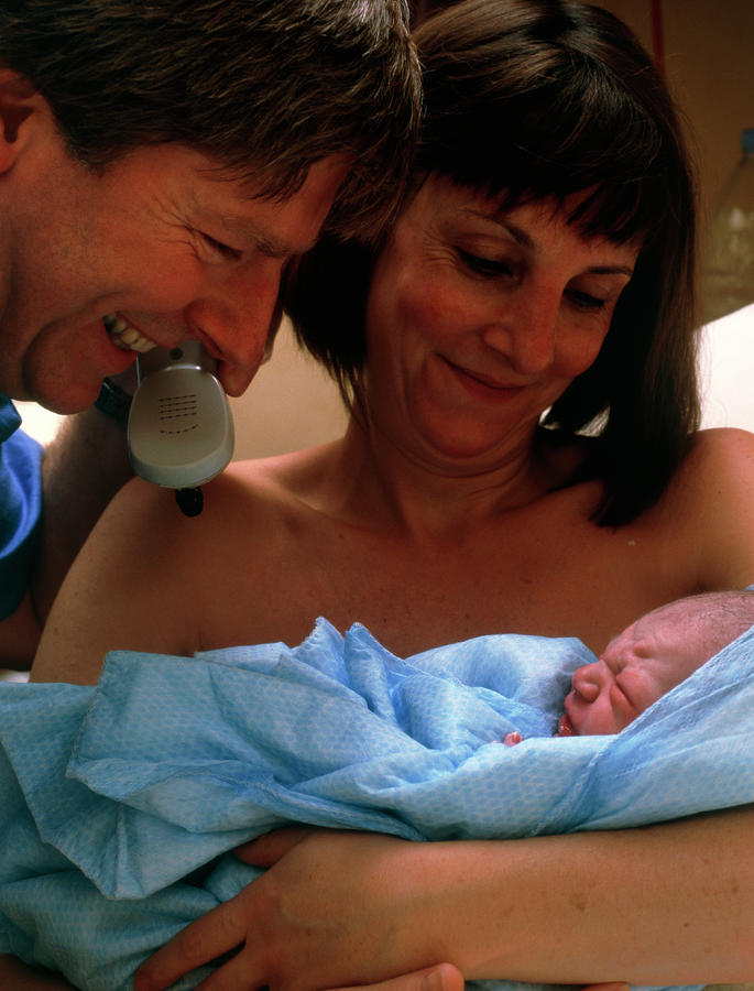 Proud Parents Looking At Their Newborn Baby Boy Photograph by Hattie Young/science Photo Library