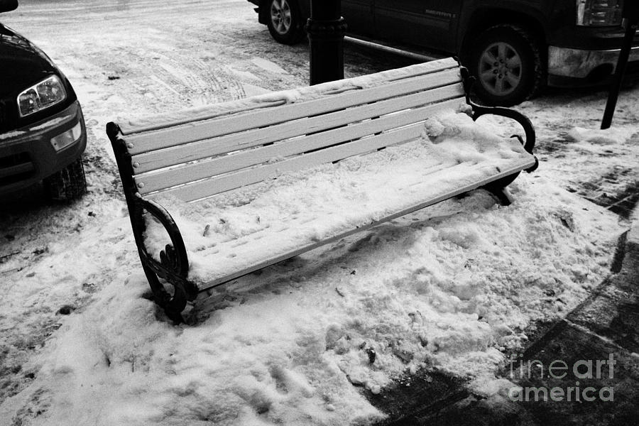 Winter Photograph - public bench covered in snow downtown Saskatoon Saskatchewan Canada by Joe Fox