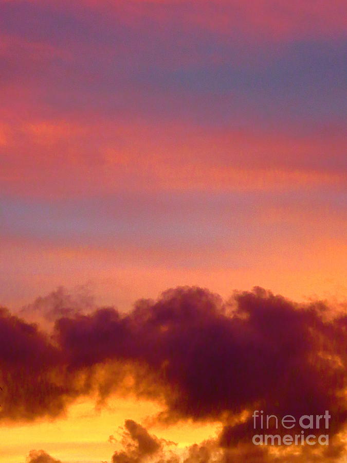 Puffy Gray Cloud against a Golden Sunset. Photograph by Robert Birkenes