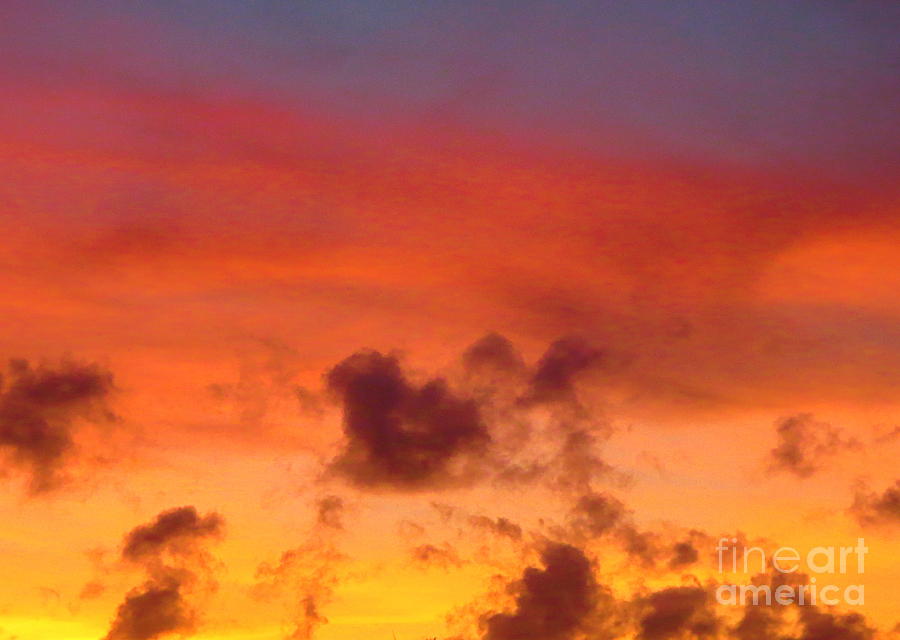 Puffy Little Gray Clouds against a Golden Sunset. Photograph by Robert Birkenes