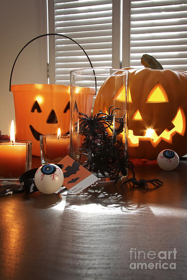 Pumpkin candles and spiders in a jar for Halloween Photograph by Sandra Cunningham