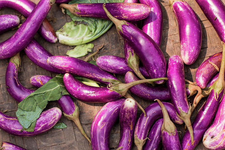 Purple Eggplants In Bamboo Basket Photograph by Merten Snijders