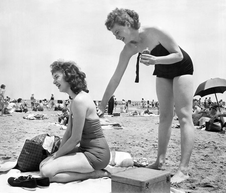 Putting On Sun Tan Lotion Photograph by Underwood Archives