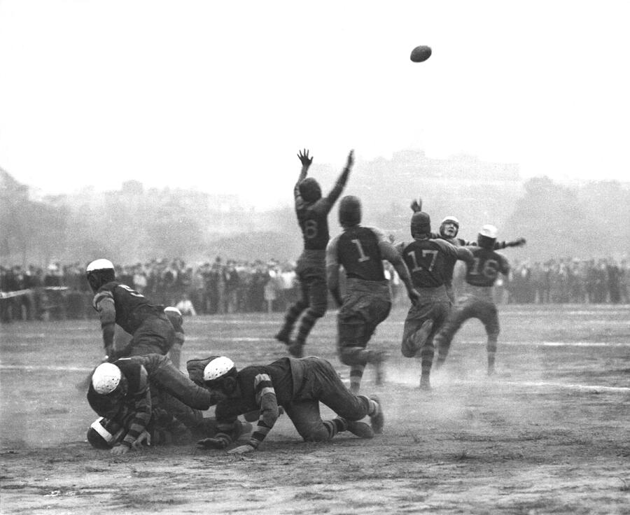 Athlete Photograph - Quarterback Throwing Football by Underwood Archives