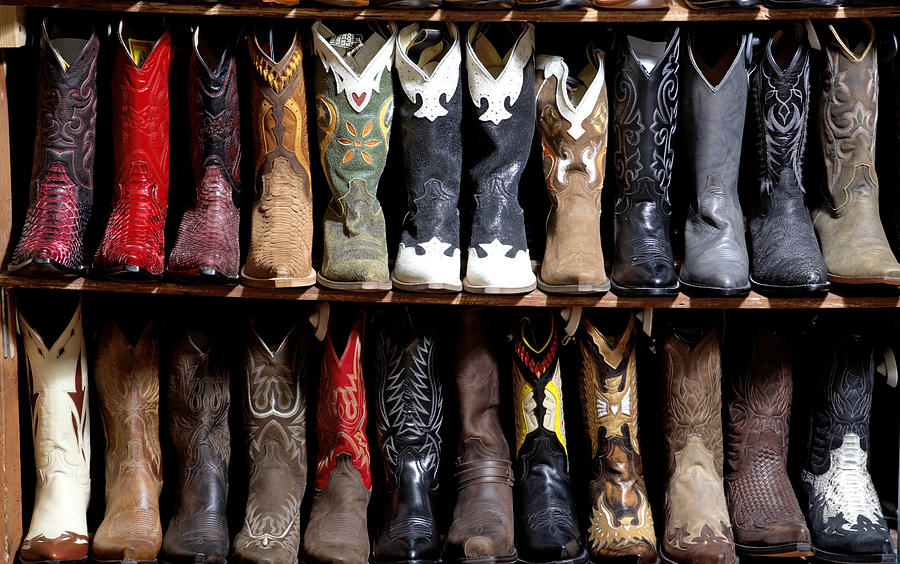 Rack of cowboy boots in shoe store, full frame Photograph by Kraig Scarbinsky
