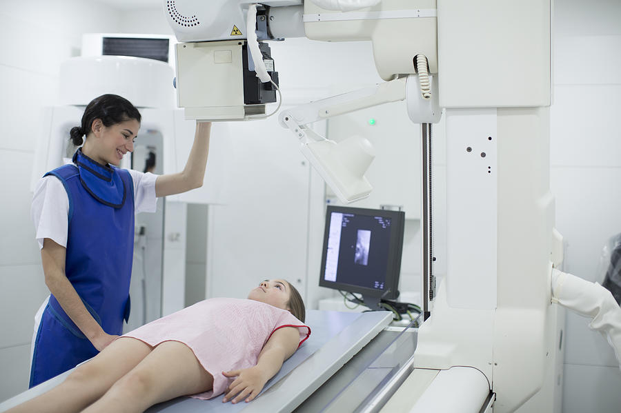 Radiologist nurse doing x-ray images. Photograph by Tempura