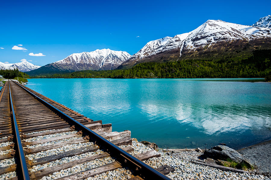 Railroad track with lake and mountain range Photograph by A&J Fotos