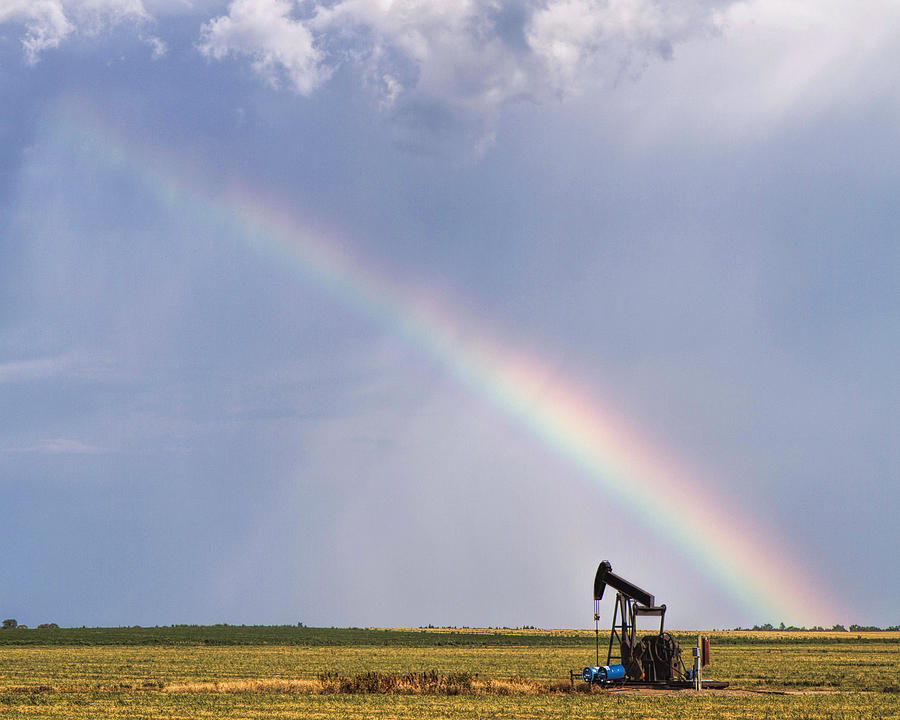 Rainbow and oil pump Photograph by Rob Graham