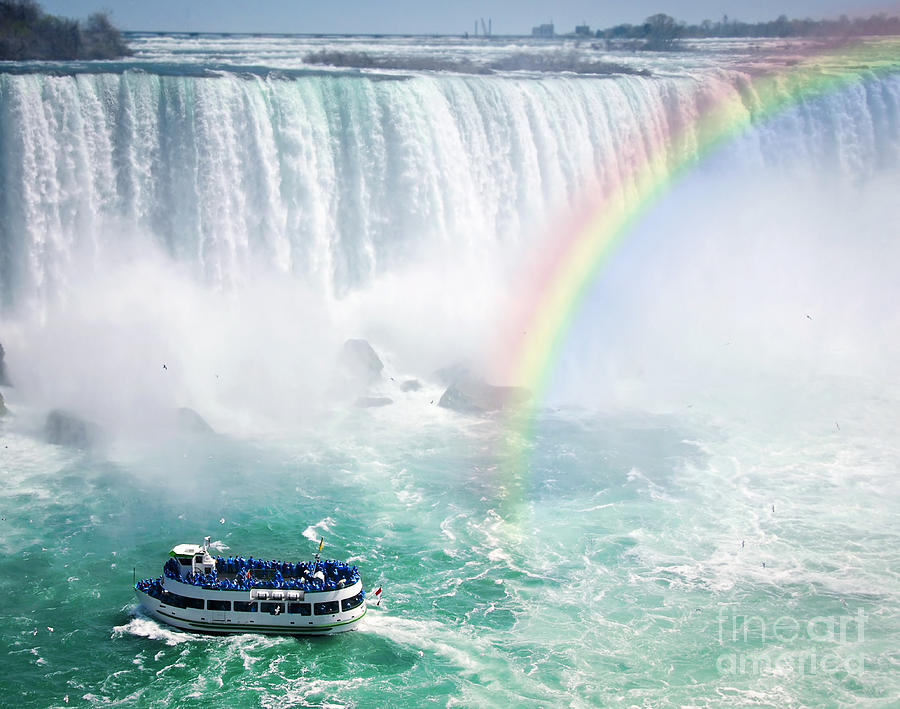 Rainbow and tourist boat at Niagara Falls Photograph by Elena Elisseeva