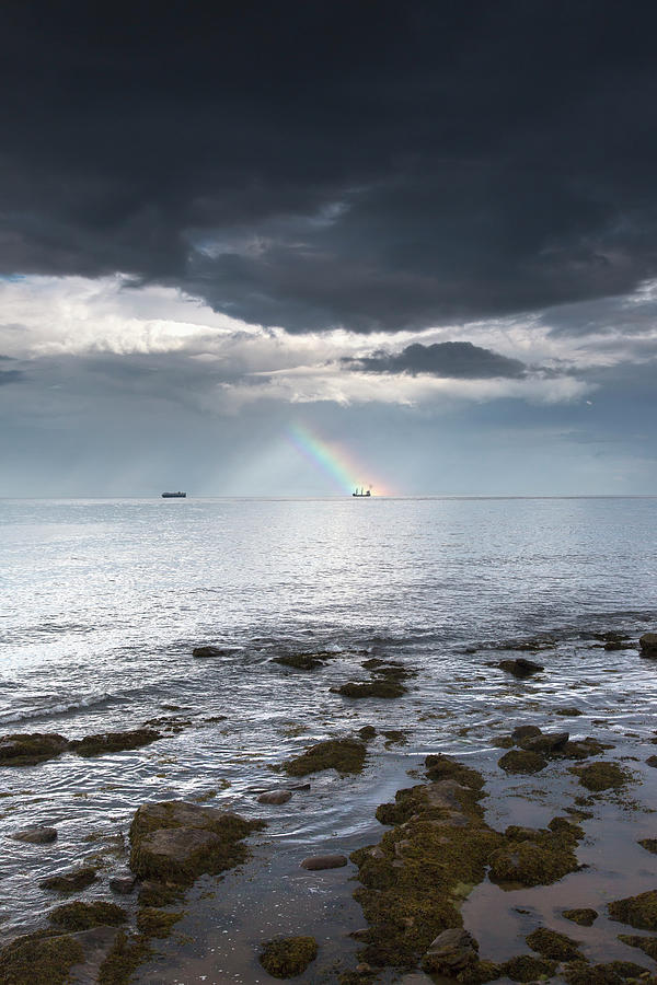 Rainbow In The Distance As Seen Off The Photograph by John Short / Design Pics
