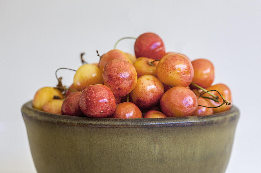 Summer Photograph - Rainier Cherries and Ceramic Bowl by Rich Franco