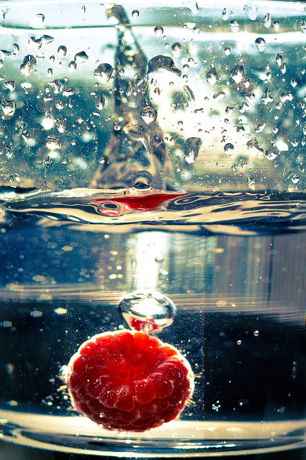 Raspberry Dropped in Water Photograph by Anthony Doudt