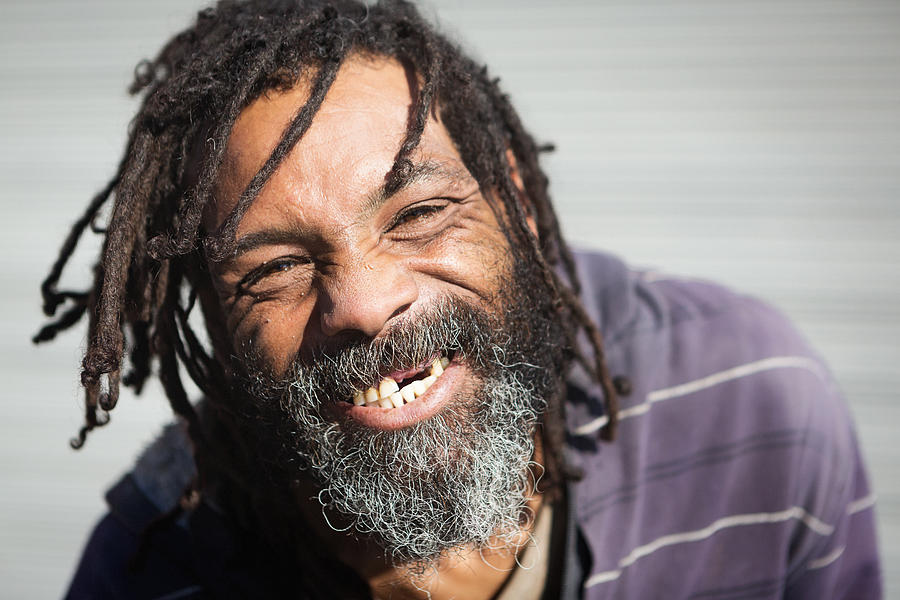 Rastafarian with missing teeth laughs Photograph by RapidEye