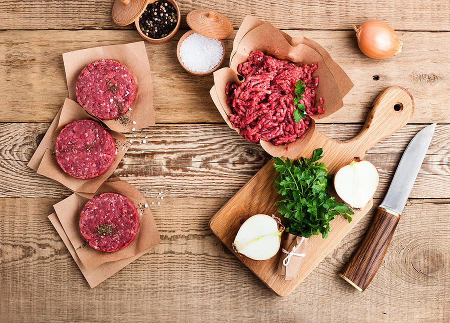 Raw ground beef meat and burger steak cutlets Photograph by Istetiana