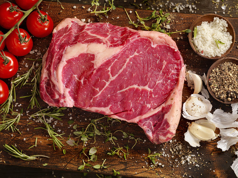Raw Rib Eye Steak with Fresh Herbs Photograph by LauriPatterson