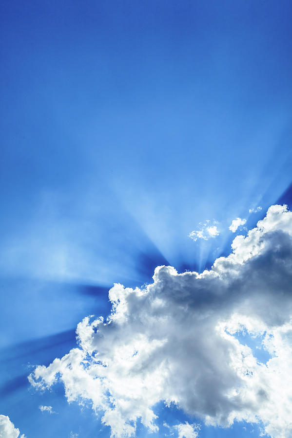 Rays Of Light Behind Clouds In A Blue Photograph by Giorgiomagini
