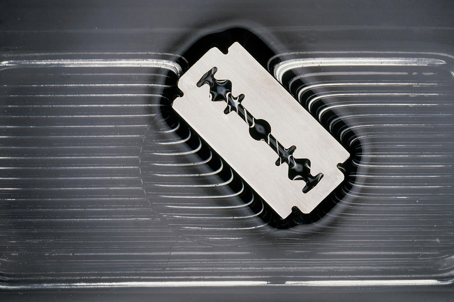 Razor Blade Floating On Surface Of Water Photograph by Peter Aprahamian/science Photo Library.
