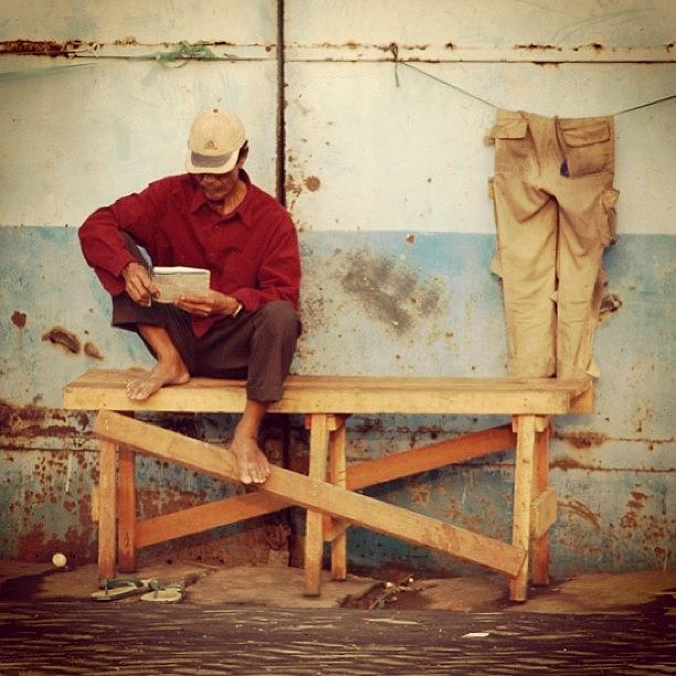 Reading... #streetphotography Photograph by Dani Daniar