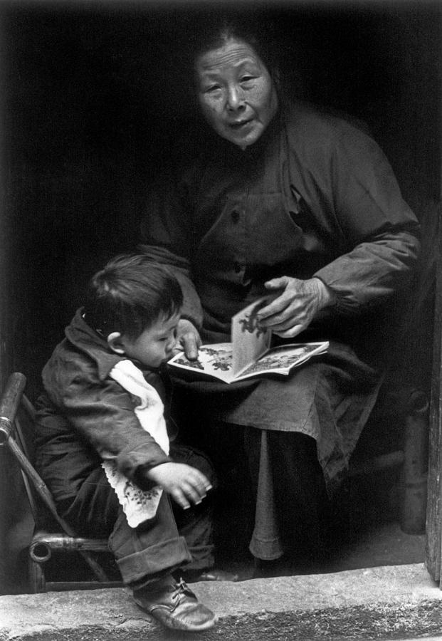 Reading to child 1981 Photograph by Dennis Cox