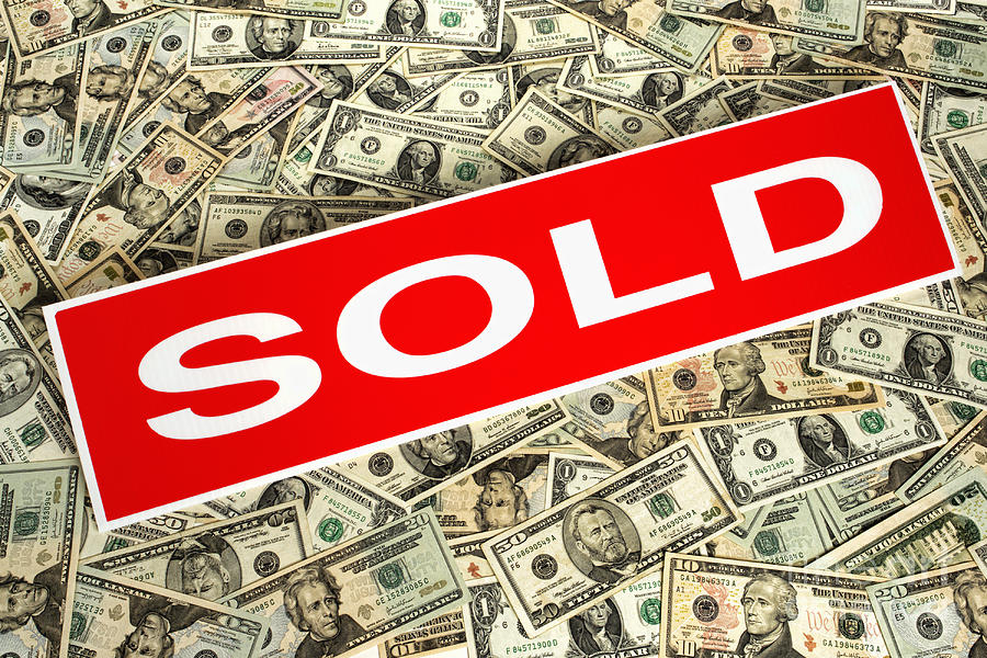 Real Estate Sold Sign over Dollar Money Background Photograph by Olivier Le Queinec