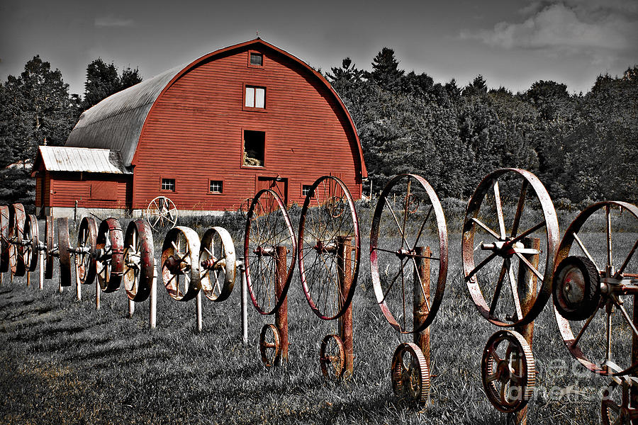 Black And White Photograph - Selective Color of Red Barn Fenced In by Wheels in Crown Point NY by Jim Swallow