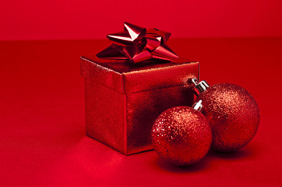 Red bauble and Christmas present  Photograph by U Schade