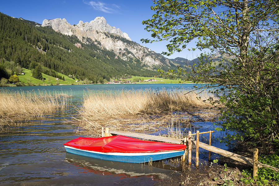 Red boat beautiful lake and mountains Photograph by Matthias Hauser